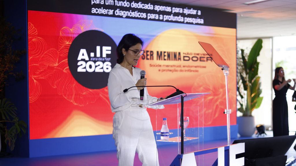 Palco do A.IF 2026 durante apresentação sobre saúde menstrual, dor pélvica e endometriose.